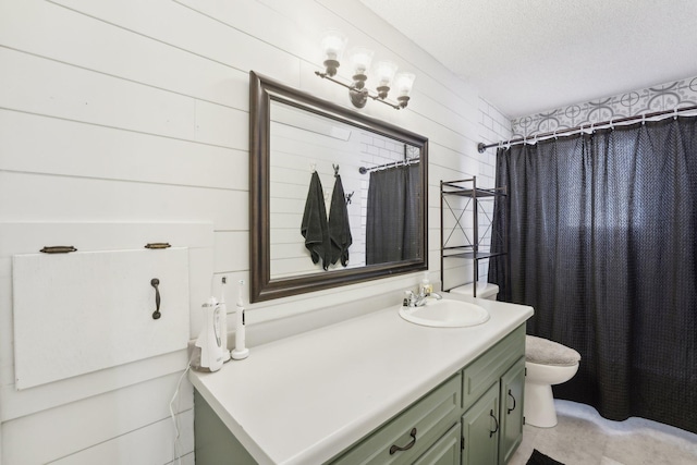 bathroom with walk in shower, vanity, a textured ceiling, wooden walls, and toilet