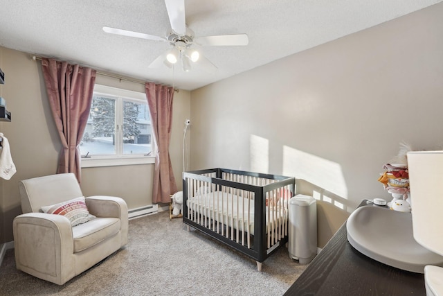 carpeted bedroom featuring ceiling fan, a crib, a textured ceiling, and a baseboard radiator