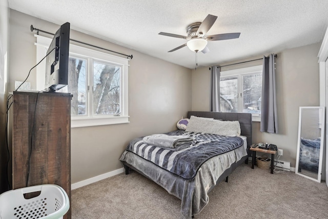 carpeted bedroom featuring ceiling fan, a textured ceiling, and a baseboard radiator