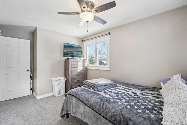 carpeted bedroom featuring a textured ceiling and ceiling fan