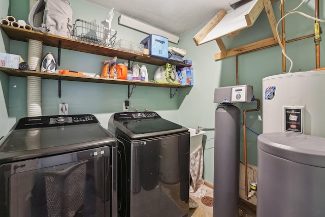 clothes washing area with washer and dryer and a textured ceiling