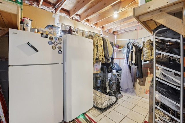 interior space with white fridge and light tile patterned floors