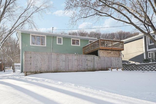 view of snow covered rear of property