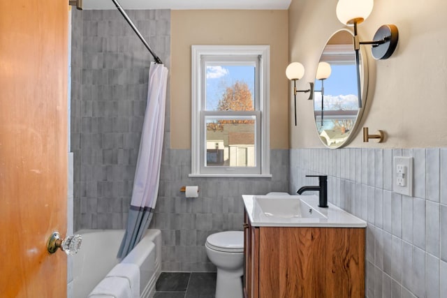 full bathroom featuring shower / bath combo with shower curtain, tile walls, tile patterned floors, and plenty of natural light