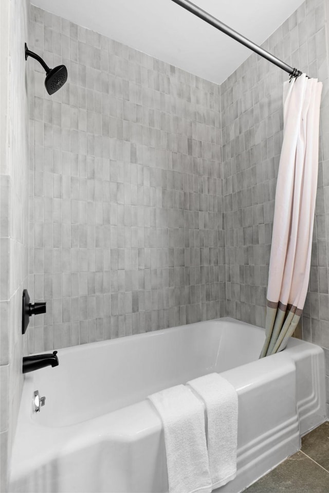 bathroom with shower / bath combo with shower curtain and tile patterned floors