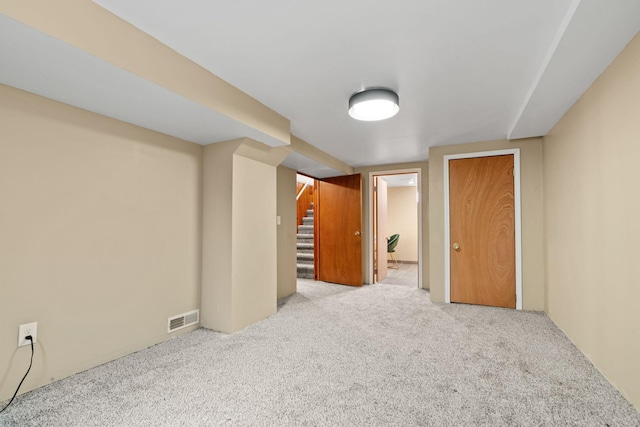 basement featuring light carpet