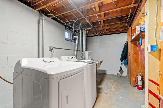 clothes washing area featuring washer and clothes dryer