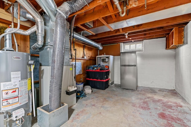 basement featuring water heater and stainless steel fridge