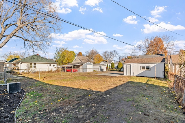 view of yard featuring central AC and an outdoor structure