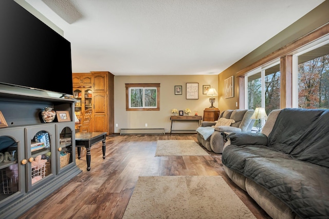 living room featuring baseboard heating and hardwood / wood-style flooring