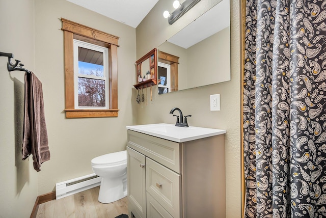 bathroom featuring vanity, hardwood / wood-style floors, toilet, and a baseboard heating unit