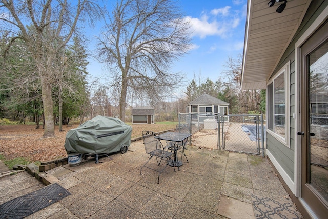 view of patio / terrace with an outbuilding and grilling area