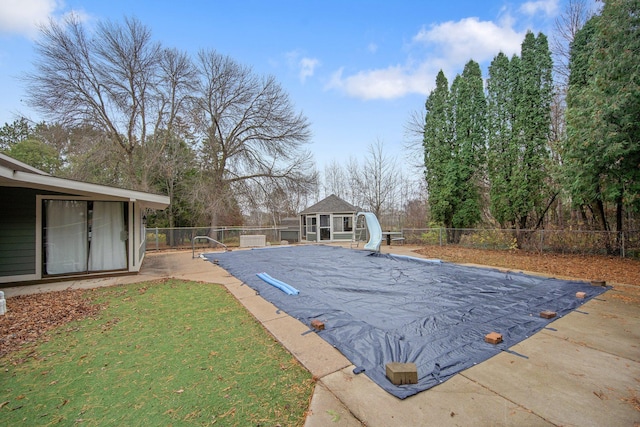 view of pool featuring a patio area and a water slide