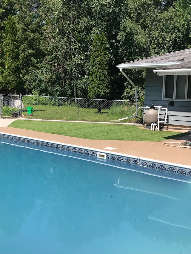 view of swimming pool with a patio area and a lawn