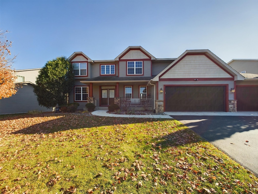 craftsman-style house featuring covered porch and a garage