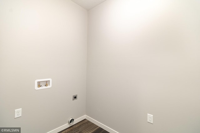 clothes washing area with hookup for a washing machine, hookup for an electric dryer, and dark hardwood / wood-style flooring