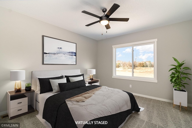 bedroom featuring baseboards, light carpet, and a ceiling fan
