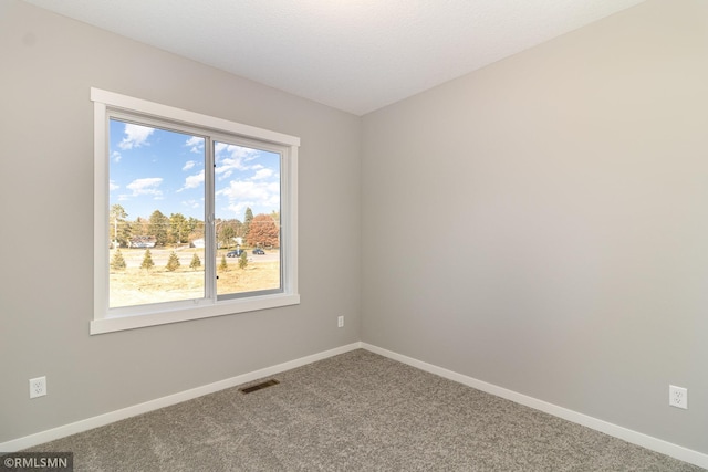carpeted empty room with baseboards and visible vents