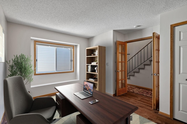 office area with dark hardwood / wood-style flooring, a textured ceiling, and french doors