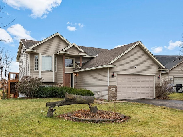 view of front of property featuring aphalt driveway, a garage, a shingled roof, stone siding, and a front yard