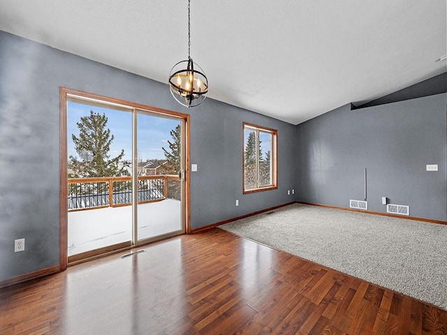 spare room with a wealth of natural light, wood finished floors, and visible vents