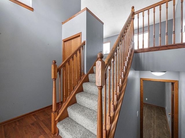 stairway featuring baseboards and wood finished floors