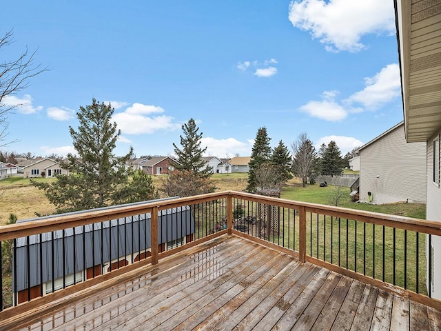 wooden terrace with a lawn and a residential view