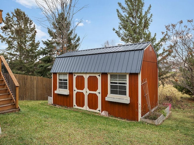 view of shed featuring fence