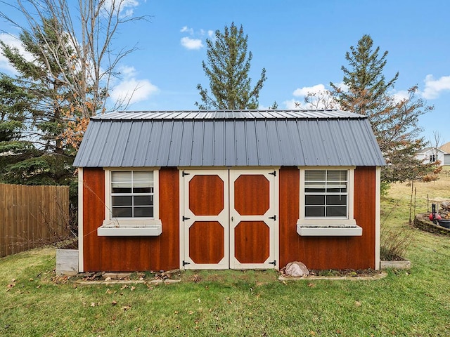 view of shed featuring fence