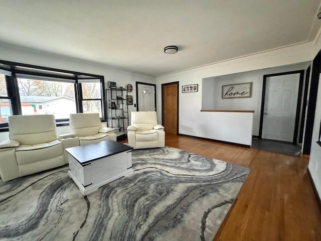 living room featuring dark hardwood / wood-style floors and crown molding