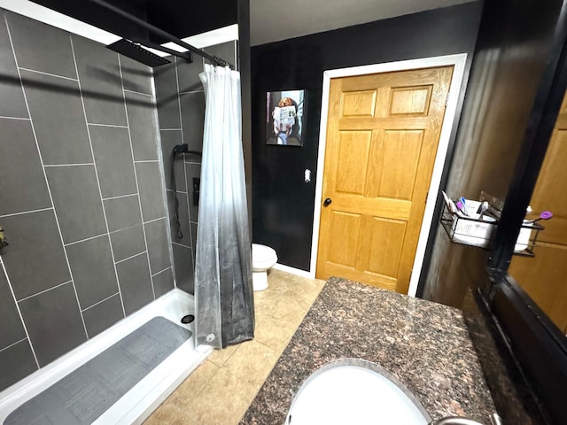 bathroom featuring walk in shower, tile patterned flooring, vanity, and toilet