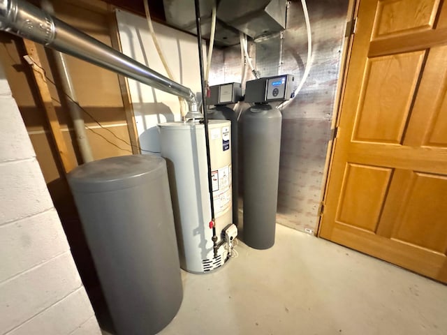 utility room featuring gas water heater