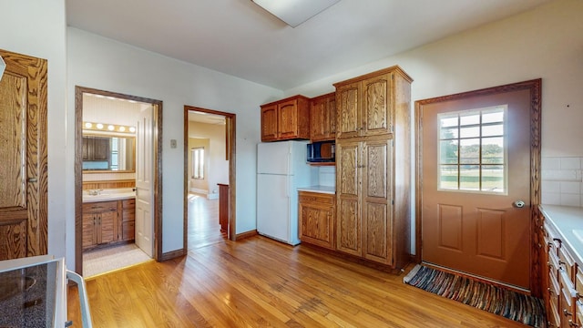 kitchen featuring light wood-type flooring and white refrigerator