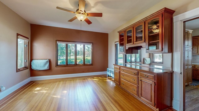 kitchen with ceiling fan and light hardwood / wood-style flooring