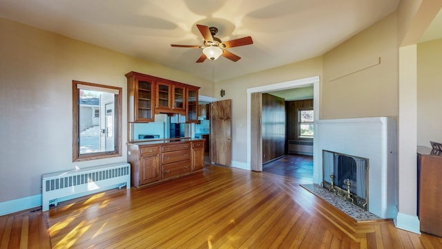 kitchen with ceiling fan, radiator, and wood-type flooring