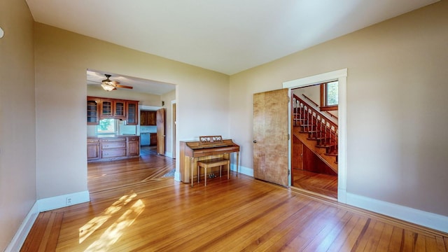 unfurnished room with hardwood / wood-style flooring and ceiling fan