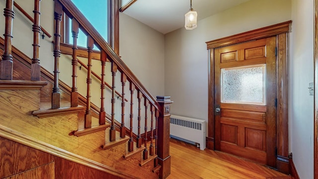 entrance foyer with radiator and light hardwood / wood-style flooring