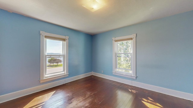 empty room with dark wood-type flooring