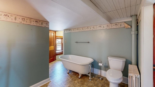 bathroom with a bathtub, toilet, and radiator