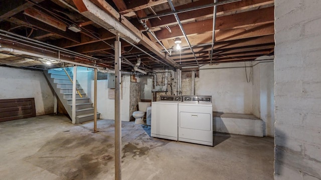 basement featuring washing machine and dryer and electric panel