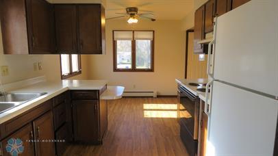 kitchen with a baseboard radiator, ceiling fan, dark hardwood / wood-style floors, black range, and white fridge