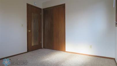 unfurnished bedroom featuring carpet and a closet