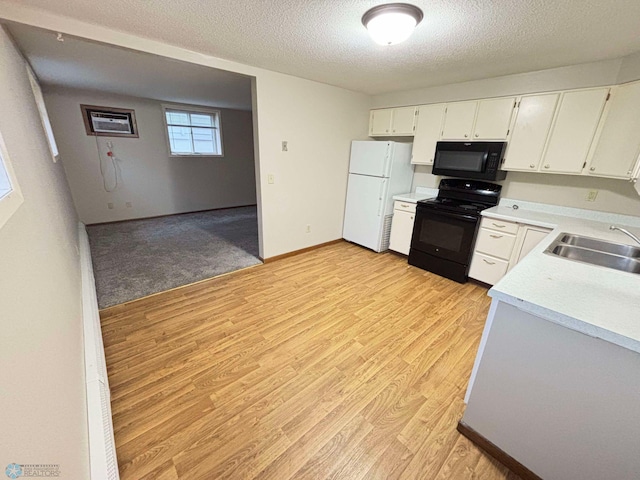 kitchen featuring white cabinetry, sink, black appliances, a textured ceiling, and light hardwood / wood-style flooring