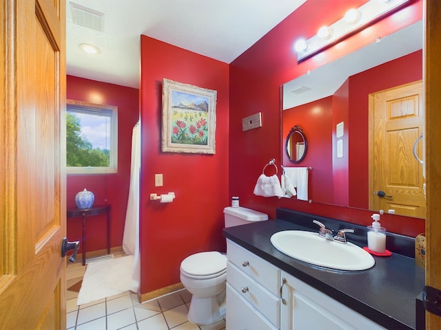 bathroom with toilet, vanity, tile patterned floors, and a shower with curtain