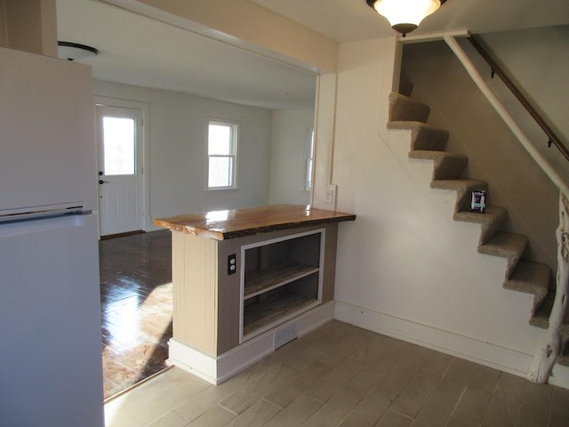 staircase with hardwood / wood-style flooring