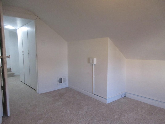 bonus room featuring light colored carpet and lofted ceiling