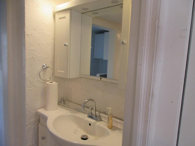 bathroom with sink and tasteful backsplash