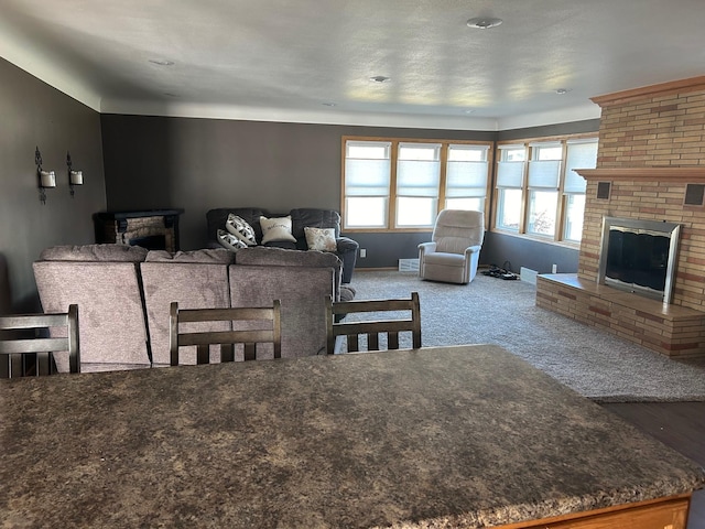 living room with carpet and a fireplace