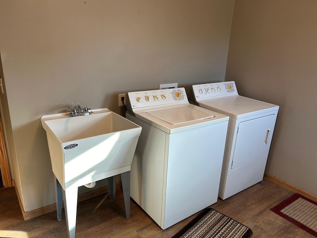 laundry area with wood-type flooring and washer and clothes dryer