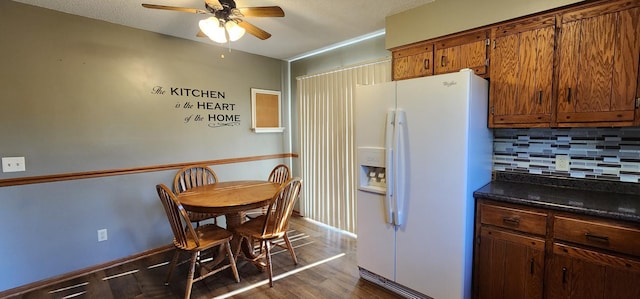 kitchen with white fridge with ice dispenser, a textured ceiling, dark hardwood / wood-style flooring, backsplash, and ceiling fan